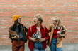 © La Famiglia - Diverse students walking on campus having fun together