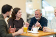 © JackF - Multi-age group of relatives in restaurant. Organization of meetings, coffee breaks, and festive dinners, family gatherings. Relatives chatting, joking, speaking, have nice conversation, enjoy meeting
