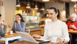 © JackF - In cozy cafe hall, freelance woman works with laptop and drinks coffee. Remote work from anywhere in world