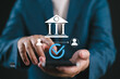 © Nirusmee - Businessman using smartphone for secure financial transactions and mobile banking, representing safe money transfer, verified payments, and digital banking solutions.