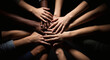 © jendralbiribiri - Diverse group of people stacking hands together in a symbolic gesture representing unity teamwork and mutual support against a dark background emphasizing collaboration