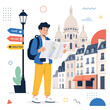 © araha - A tourist consults a map while standing in front of historic buildings