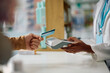 © Drazen - Close up of man using credit card while paying in pharmacy.