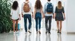 © GraphixStudio - Five people walking in a modern office corridor, casual attire