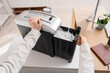 © Pixel-Shot - Female hands using shredder in office