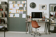 © AnnaStills - Wide shot of modern home office workspace displaying desktop computer with coding screen, planning board, notes, documents. Supporting remote work, software development, productivity content