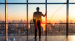 © Julie - Businessman stands admiring the sprawling city at sunrise, envisioning a successful and bright future.