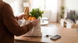 © Mary - A person unpacks fresh groceries from a reusable cloth bag onto a kitchen counter.