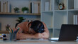 © itchaznong - East Asian man suffering burnout and exhaustion sleeping on desk from overwork
