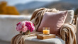 ©  VladaToday - Cozy home self care corner with armchair blanket candle and flowers for relaxation background and lifestyle banner