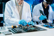 © Nuttapong punna - The technician is putting the CPU on the socket of the computer motherboard. electronic engineering electronic repair, electronics measuring