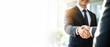 © NanNapa - Business handshake: Captured in a moment of mutual respect and agreement, two professionals seal a deal with a firm handshake, symbolizing partnership. This image captures collaboration and success.