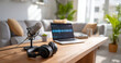 © perfectlab - Home podcasting setup with microphone, headphones, and laptop displaying audio editing software on wooden table in cozy living room
