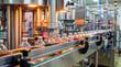 © SIMANG - Automated beverage filling production line in operation with glass bottles on conveyor belt