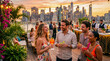 © Argiduna - Grupo de amigos disfrutando una fiesta de verano en una azotea de lujo al atardecer con ambiente tropical y estilo premium.