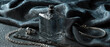 © whitehoune - Moody luxury still life featuring a premium clear glass perfume bottle with condensation on a matte black stone slab. Silver jewelry rests on deep charcoal silk fabric with dramatic lighting