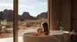 © Qii Stock - Woman Relaxing in a Free-Standing Tub Overlooking a Mountain Landscape