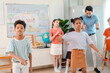 © chokniti - Back to school and education concept of children dancing in classroom with teacher, playful learning and group activity in bright elementary school room