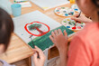 © chokniti - Back to school and education concept of children painting watercolor on canvas at table, creative art activity with paint palette and brush