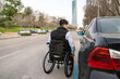 © Koldo_Studio - Man in wheelchair using urban parking, showcasing accessibility and independent mobility in a modern city environment