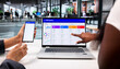 © Andrey Popov - Marketing Team Members Collaborate Using Laptop And Smartphone