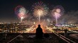 © riedoak - Person sitting on rooftop watching vibrant fireworks display over cityscape at night