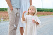 © offsuperphoto - Family moment captured outdoors with a child blowing bubbles on a path