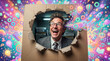 © Tania Zbrodko - Serious businessman bursting through cardboard box creative concept