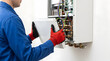 © Mahmuda - professional boiler maintenance service | HVAC technician repairing heating system | gas boiler inspection and annual service | heating engineer removing boiler casing