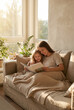 © Renie - Mother hugging child while reading a book on a living room sofa by a sunny window