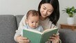 © Studicon - Mother and child enjoying story time together on the couch in a brightly lit home