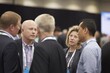 © Juan - Business professionals networking and conversing at conference