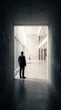 © Hermansah - A man in a suit standing at the entrance of a modern office building.
