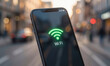 © Юлия Васильева - Smartphone with Wi-Fi symbol on screen in urban setting