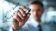 © Punnn - Growth Chart Analysis: A businessman in a suit carefully draws an upward trending graph on a glass surface, symbolizing business growth, financial progress, and strategic planning.