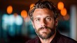 © svastix - A charismatic man with a well-groomed beard exudes confidence and style, presenting a portrait of modern masculinity in a relaxed setting perfect for social interactions.