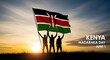 © MdNurul - Three people holding the kenya national flag high at sunset for madaraka day in june