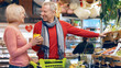 © Prostock-studio - A man and a woman are shopping at a grocery store in the afternoon. They are smiling and looking at fresh produce. The man holds a yellow bell pepper while the woman points at the vegetables.