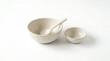 © Malik - ceramic bowls and spoon on white background