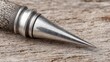 © madur - Sharp Metal Spike Tine Against Textured Wood Surface
