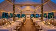 © Tin - A beautifully decorated wedding tent with lights, flowers, and elegant dining arrangements.