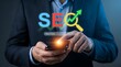 © Abdurrahman Bin Auf - SEO Digital Marketing Strategy: Professional hands optimizing website ranking with mobile internet solutions on a glowing holographic smartphone for business growth and online success.