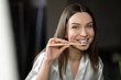 © zinkevych - Long-haired young woman brushing her teeth in the morning