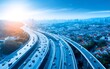 © vectorizer88 - Aerial view of busy highway road with multiple lanes under clear blue sky