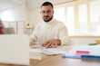© Pixel-Shot - Male interior designer working at table in office