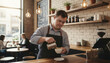 © Zireael - Young man with down syndrome enjoying work as barista in a cozy café setting. promoting inclusivity and empowerment through employment opportunities.