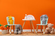 © New Africa - Table with chairs and toys near orange wall in child's room. Space for text