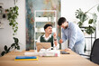 © Studio Marmellata - Two men collaborate at a desk with a laptop, one pointing and explaining an idea to the other who is smiling and giving a thumbs up.