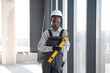 © Serhii - Construction worker holding spirit level smiling at construction site