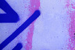© vejaa - Abstract grunge painted wall texture with bold neon pink purple painted strokes and chaotic urban street art spray patterns.